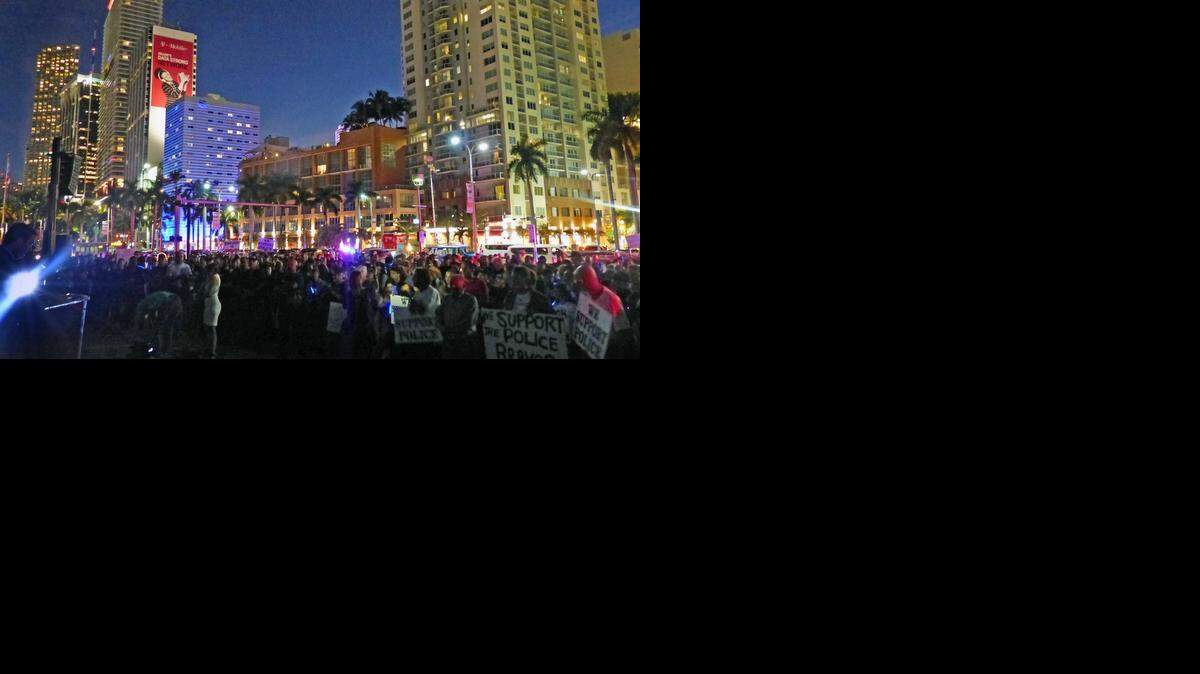 
Hundreds gather at the Torch of Friendship at Bayside in downtown Miami on Monday, Dec. 29, 2014, to honor NYPD officers Rafael Ramos and Wenjian Liu, who were gunned down Dec. 20.
