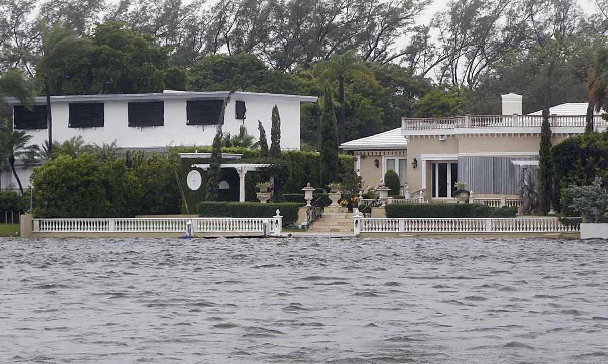 The level of the water almost overflow in the backyard of a house at the canal along Collins Avenue as Hurricane Irma began to swing west of Miami avoiding direct hit bringing stormy weather into Miami-Dade County, on Saturday, Sept. 9, 2017.