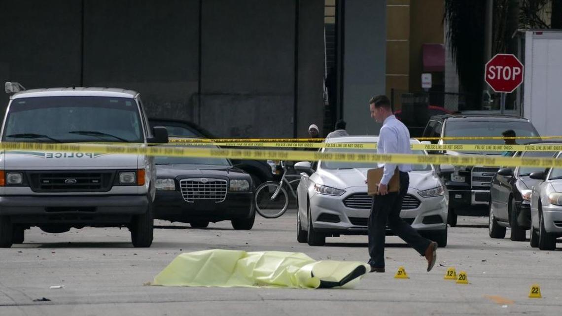 The body of 18-year-old Eddie Harris Jr. is covered by tarp after he was shot and killed Friday, Jan. 29, 2016, at 5200 NW 26 Ave. in Miami.
