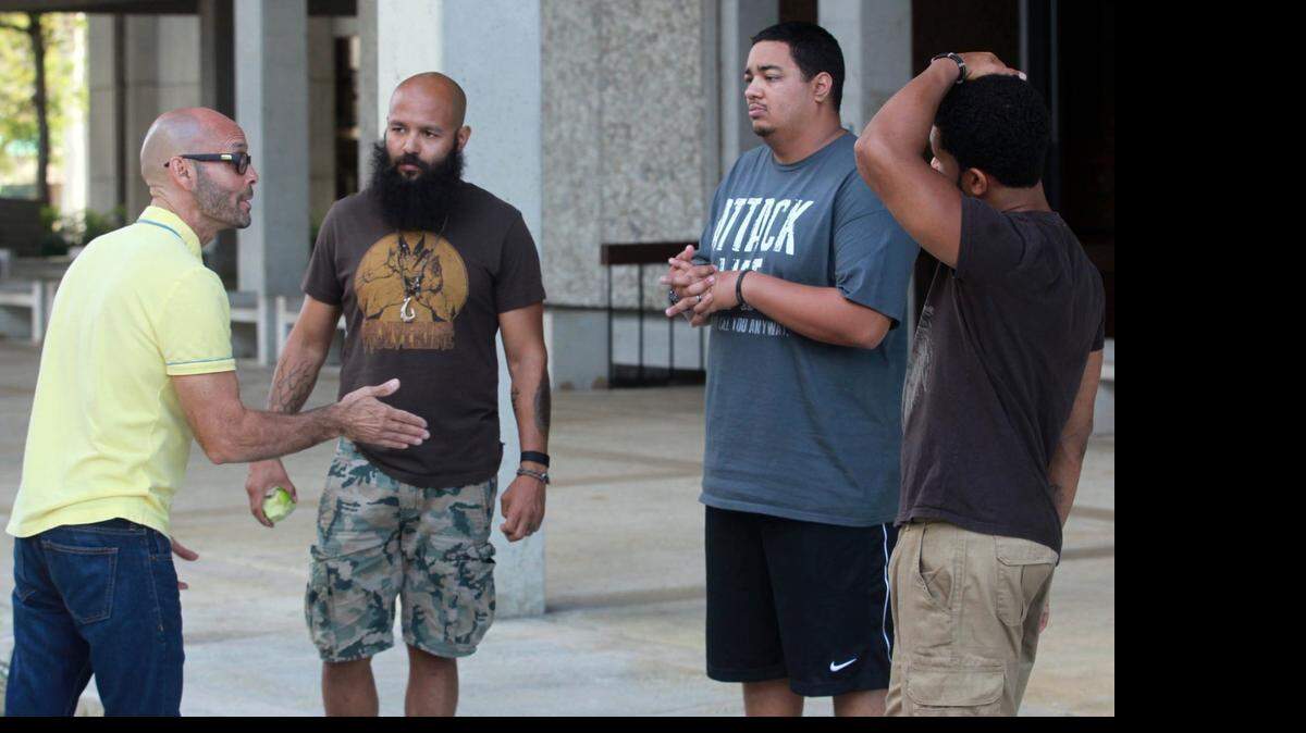 
Teo Castellanos, (left) an actor and director, talks to Hipolito Arriaga, (center left) and Anthony Torres, (center) and Andrew Cuthbert, (right) who are veterans, as they prepare for an upcoming poetry performance. Much of their material is inspired by their time in combat zones in Iraq. 

