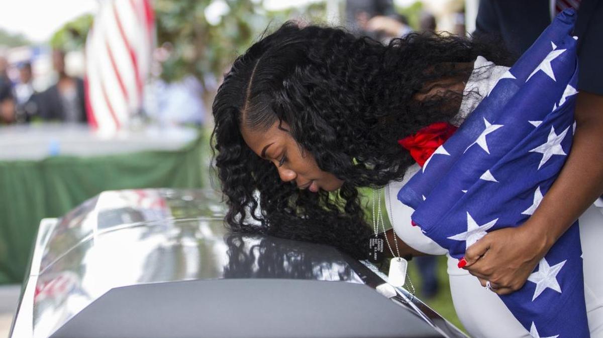 Myeshia Johnson kisses the casket of her husband, Sgt. La David Johnson, during his burial service in Hollywood on Saturday, Oct. 21, 2017.