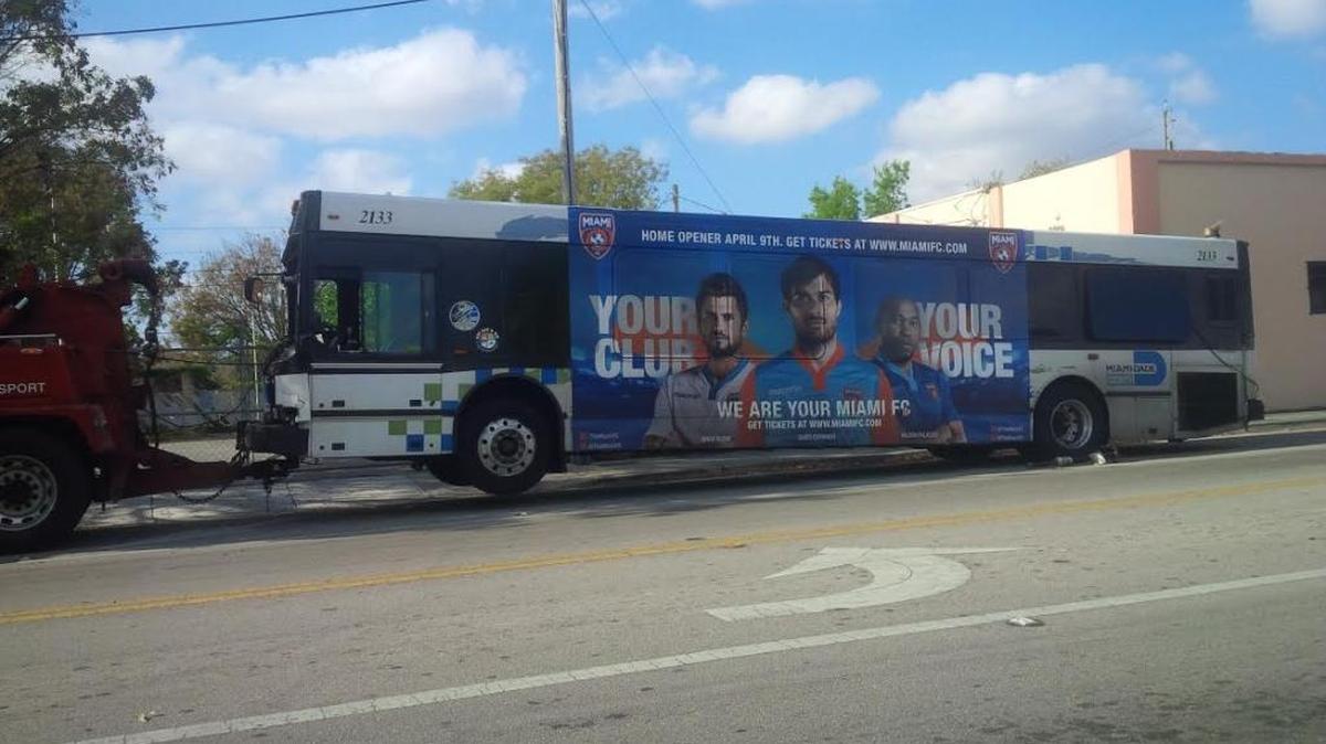A Miami-Dade bus gets towed after a crash Wednesday morning in Miami.