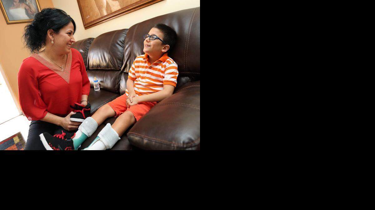 
Yordanka Fernández with her son Nicholas, 8, who suffers from cerebral palsy and other health issues, at their home in Hialeah.


