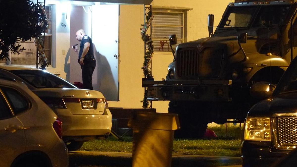 Police surround a house at 125 West 56th Street in Hialeah where a man had barricaded himself on Wednesday, Dec. 23, 2015.