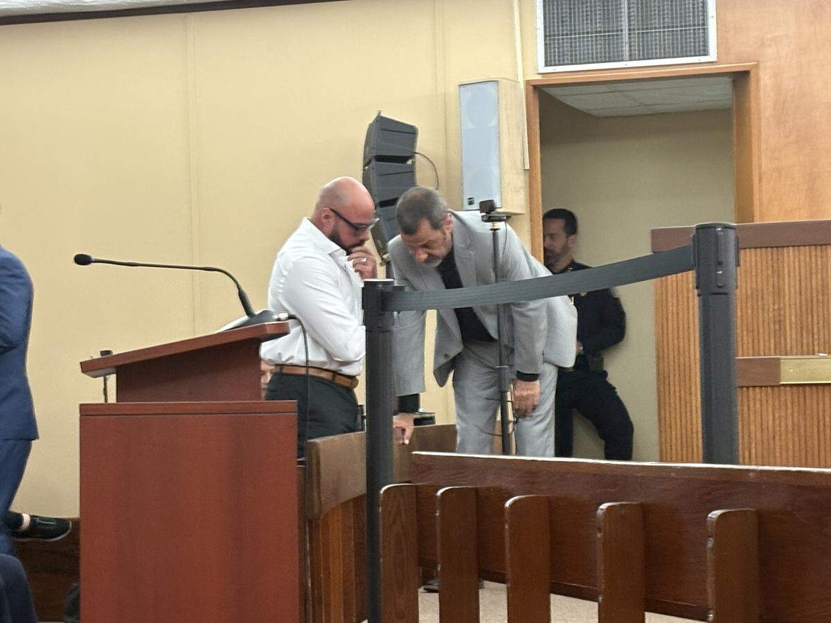 Councilman Carl Zogby speaks with COHEA charter school principal Carlos Alvarez before the council meeting began. Zogby was the only one of the seven council members who spoke in favor of the proposal to expand the school over two multipurpose fields located in Slade Park.