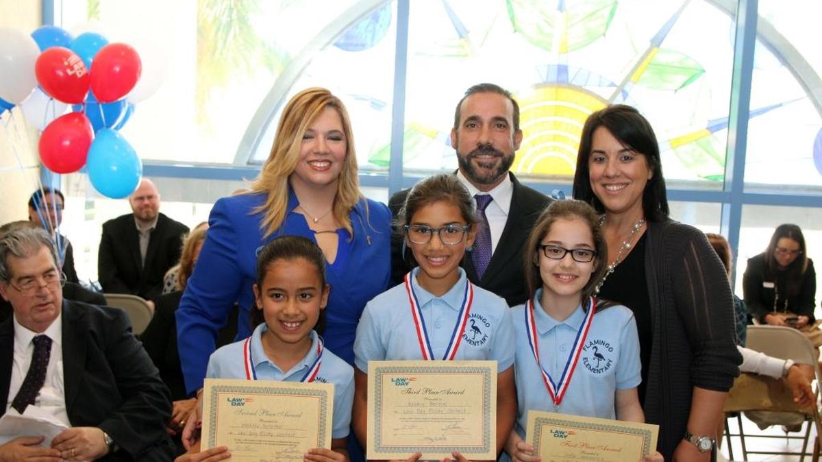 Flamingo Elementary School students Melanie Petitfour, Ashley Bernal and Sofia Gonzalez receive awards for their essays on Miranda rights during a Law Day celebration on May 6 at the Hialeah Courthouse. Back row, event sponsors County Judges Don Cohn and Victoria Ferrer and Richard and Jannette Patino.