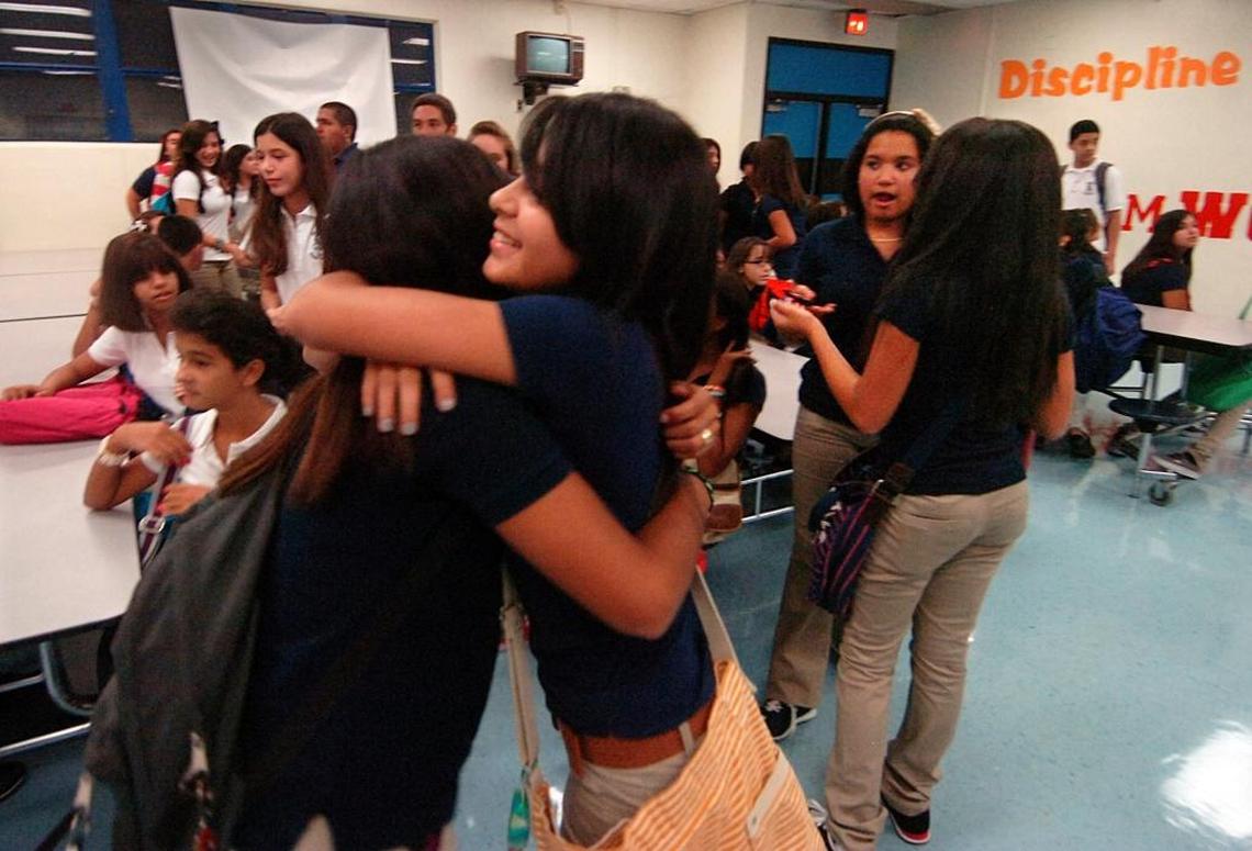 Julie Torres, left, an eighth grader, gets a big welcome back hug from Franchesca Forero, right, a seventh grader as they arrive for the first day of school at Jose Marti Mast 6-12 Academy at 5701 W. 24th Ave. in Hialeah at 7:15 a.m. on Aug. 22, 2011.