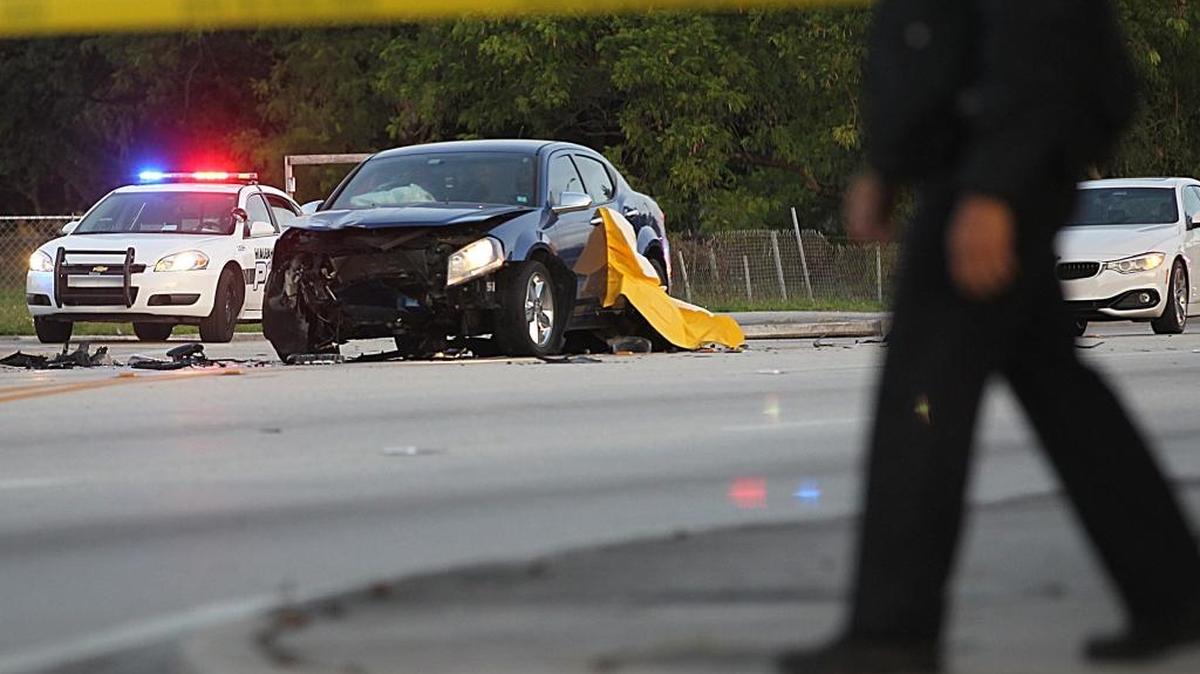 Hialeah police officers closed off the scene of a crash between a car and a motorcycle on 8th Avenue (Le Jeune Road) and SE 10th Street in Hialeah, on Friday December 30, 2016.