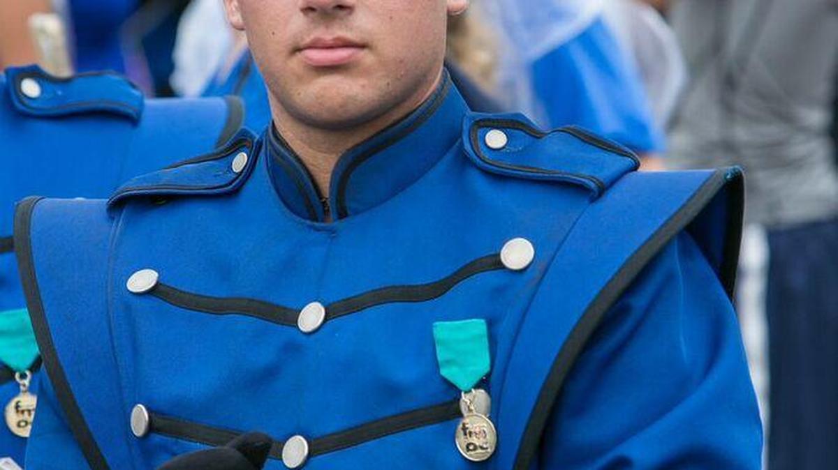 Blake Regalado, senior and trumpet player in the Hialeah High Marching Band, wears his four-year band pin.