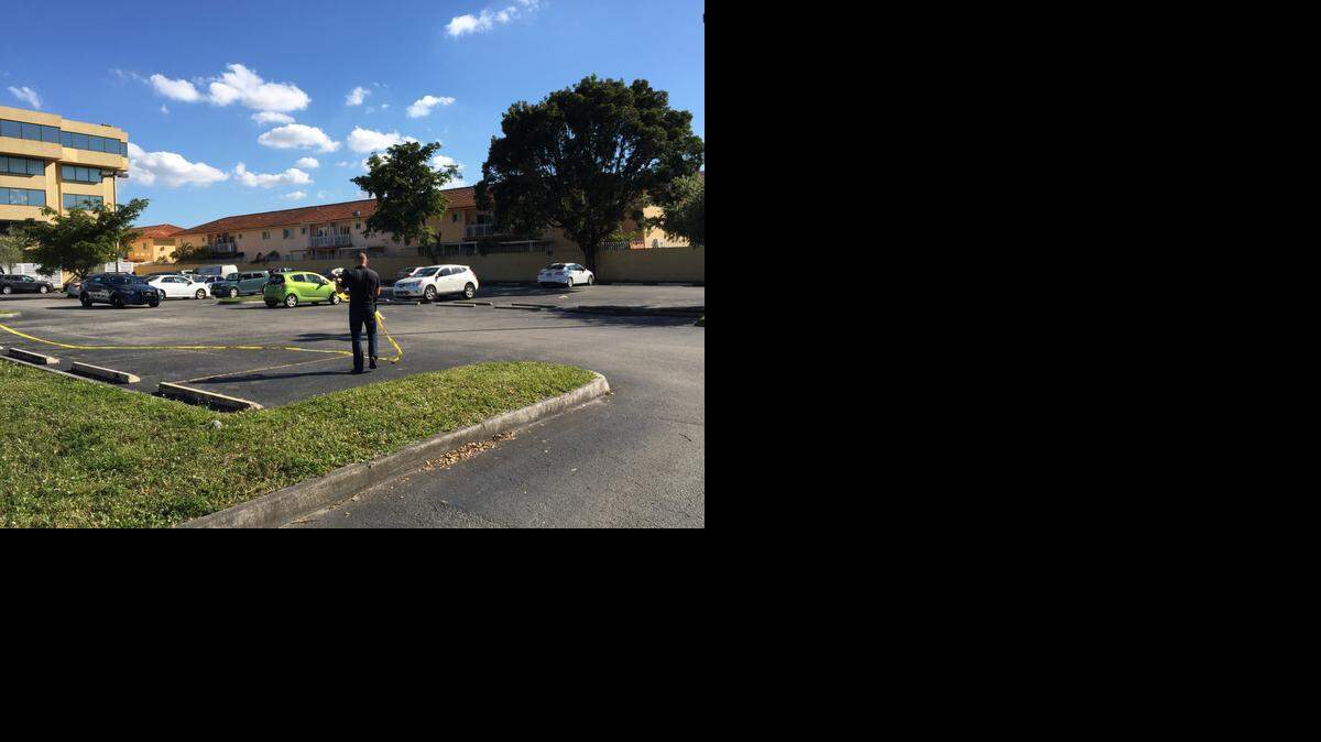 
A Hialeah police staffer removes crime-scene tape from Las Tabernas de Wancho at 2100 W. 76th St. on Sunday,

