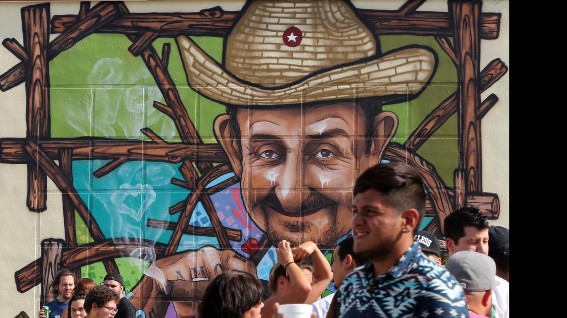 
Street party attendees gather by a mural titled "El Viandero" by artist donrimx in the new Leah Arts District in Hialeah at 1501 E. 10th Ave. on Sunday, May 17, 2015.
