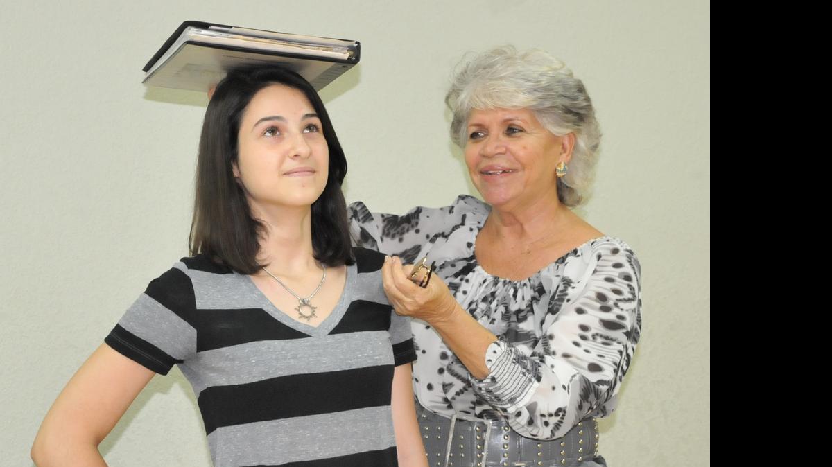 
Future Ladies: Onix Morera, right, teaches Maria Lopez, 15, good posture as part of the Future Ladies of America program.
