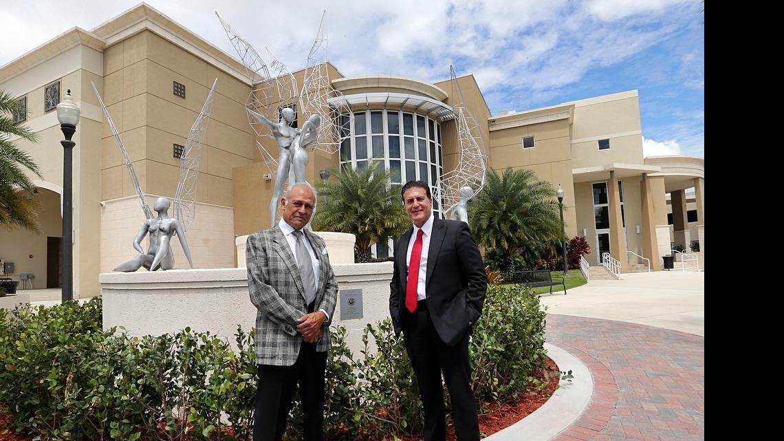 
Cuban artist Rafael Consuegra, left and Hialeah Mayor Carlos Hernandez on May 6 pose near the 'Illusions' sculpture at the Milander recreational complex .
