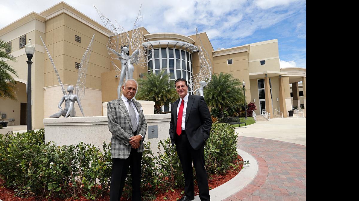 
Cuban artist Rafael Consuegra, left and Hialeah Mayor Carlos Hernandez on May 6 pose near the 'Illusions' sculpture at the Milander recreational complex .
