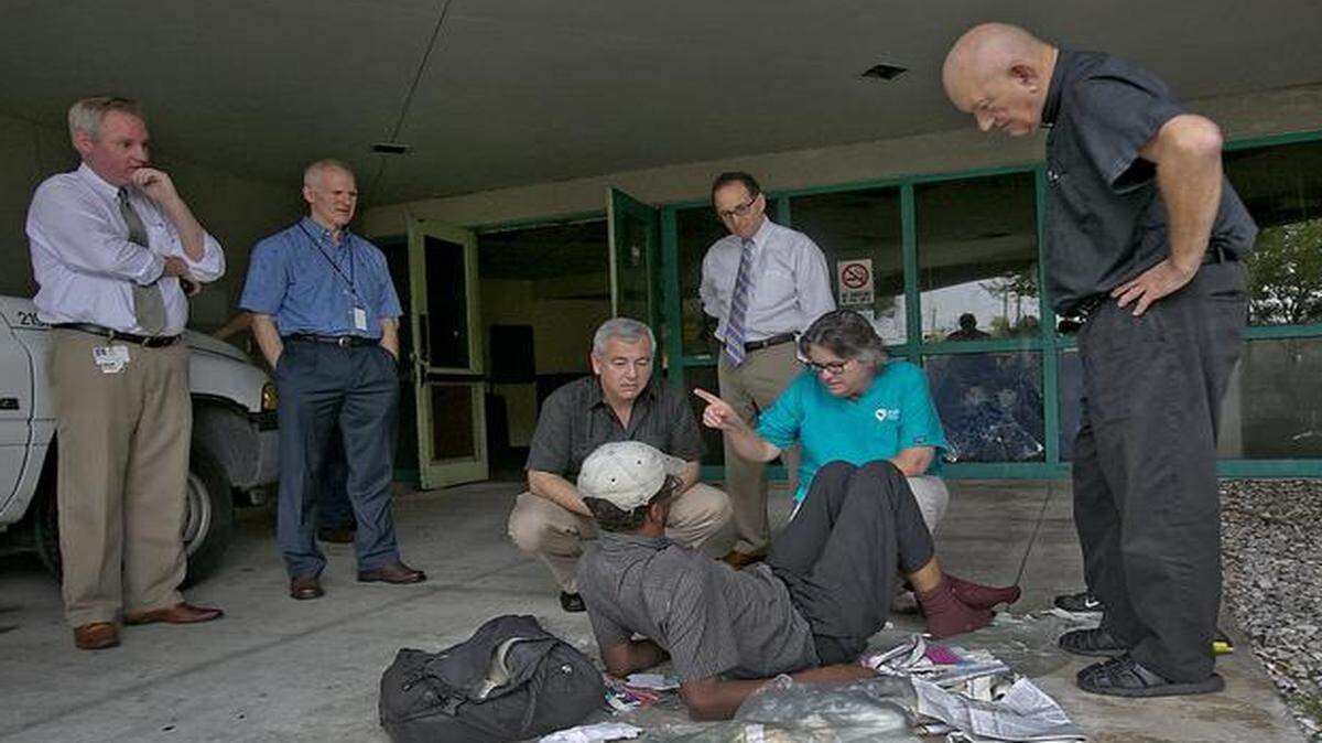 
Nurse Practitioner Rose Anderson with Camillus Health, alongside Camillus Health Executive Director Shed Boren, chats with Amos Moss, a homless man. They met and helped Moss as Miami-Dade Circuit Judge Steve Leifman (rear, in white shirt) gave a tour of a former state mental hospital in Miami slated for renovation.


