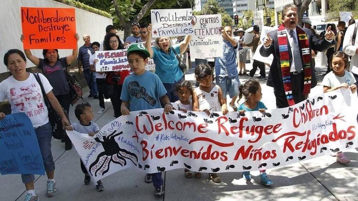 In this July 7, 2014 photo, immigrant families and advocates rally in response to President Barack Obama's statement on the crisis of unaccompanied children and families illegally entering the United States, outside the Los Angeles Federal building. Tackling what he called a humanitarian crisis, Obama in July 2014 asked Congress for $3.7 billion to cope with a tide of minors from Central America who are illegally crossing the U.S. border, straining immigration resources and causing a political firestorm in Washington.