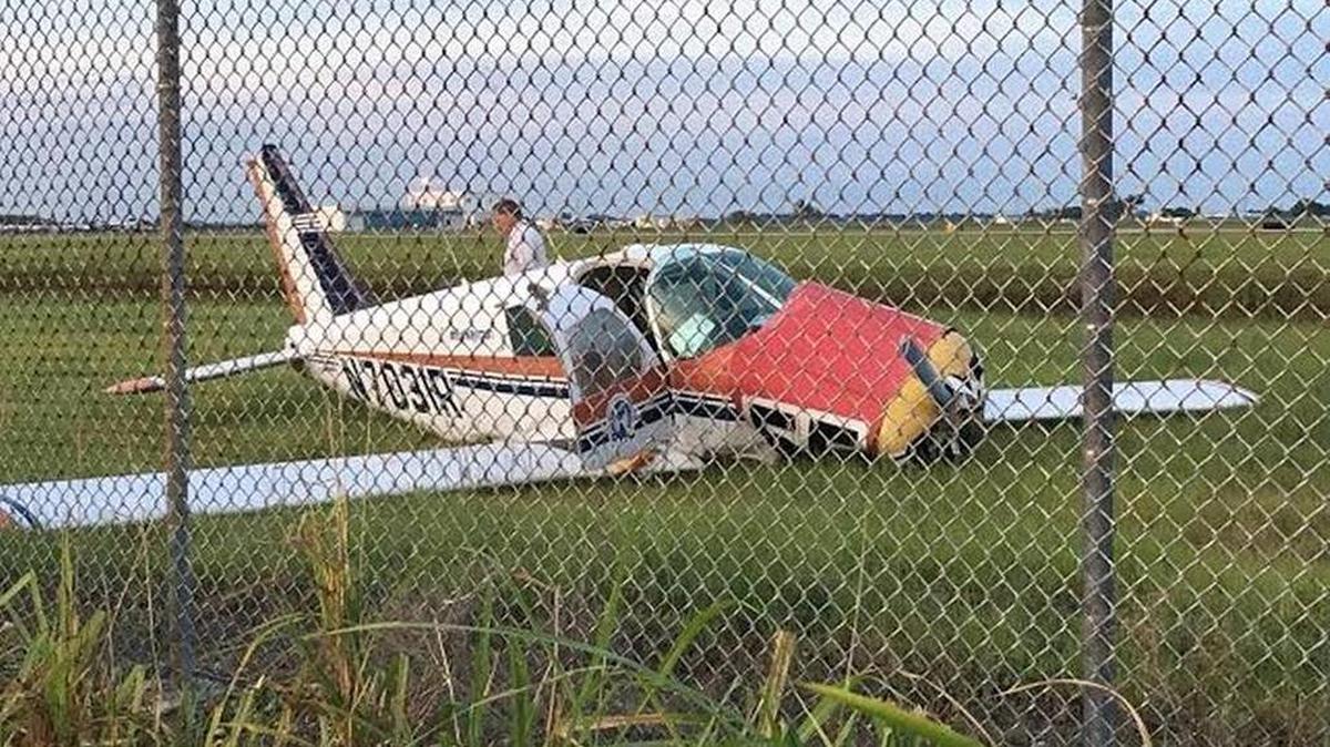 The crashed plane sits crumpled at Homestead airport on Monday.