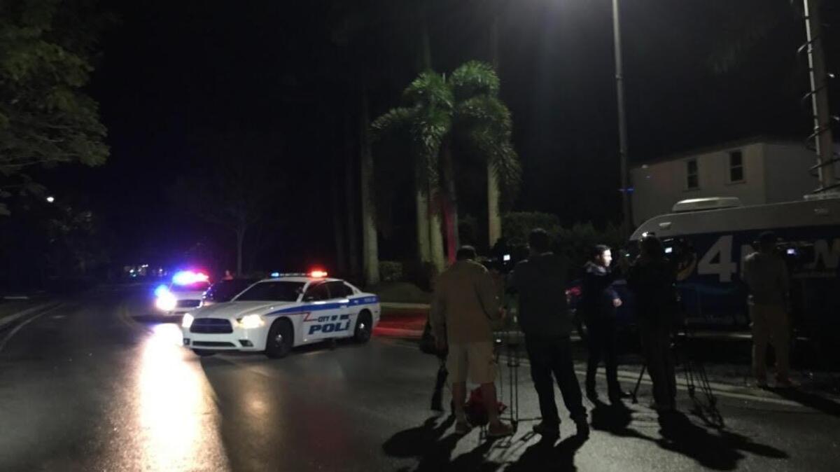 Police and media outside the Isles at Oasis complex in Homestead.