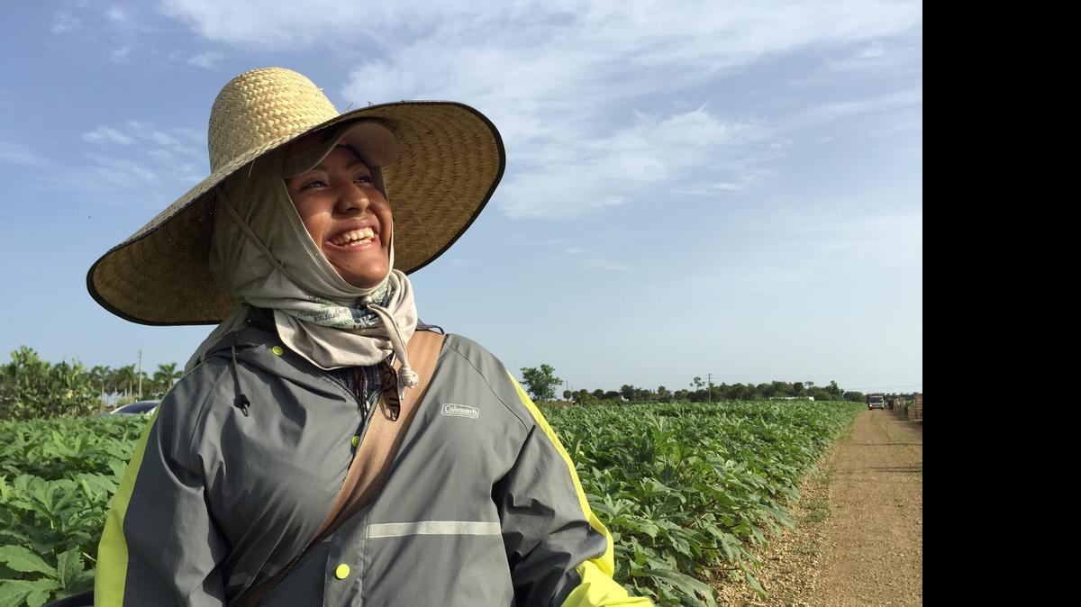 
Catalina Santiago, 18, looking delighted after receiving a Cool Tie from Community Art Cool Ties founders Suzanne Moe and Marcela Noriega. The two ladies started the project to help address the heat problem that farm workers face. They intend to take the project across the state and beyond.
