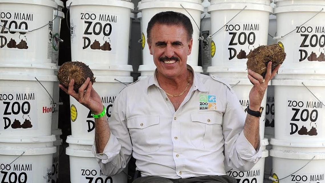 Ron Magill holds elephant dung in front of buckets of Zoo Doo, compost made from manure that is now being sold to the public.
