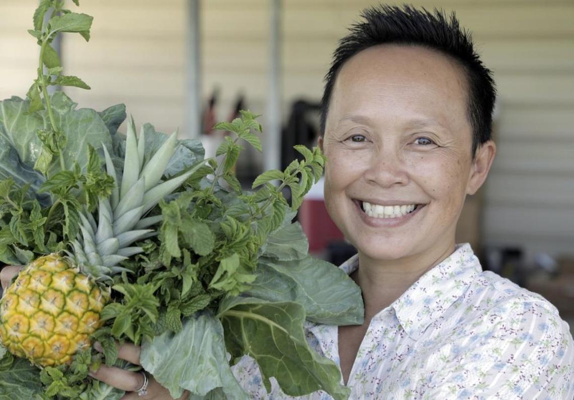 Thi Squire, community garden project manager for Grow2Heal at Homestead Hospital, shows off some of the produce grown in the hospital’s garden.