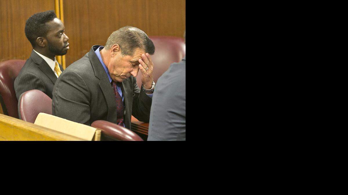 
Steven Bateman holds his head, alongside one of his attorneys Michael Davis, as jurors comeback on Monday September 22, 2014 to find the former Homestead mayor guilty of two felony counts of illegal compensation. 

