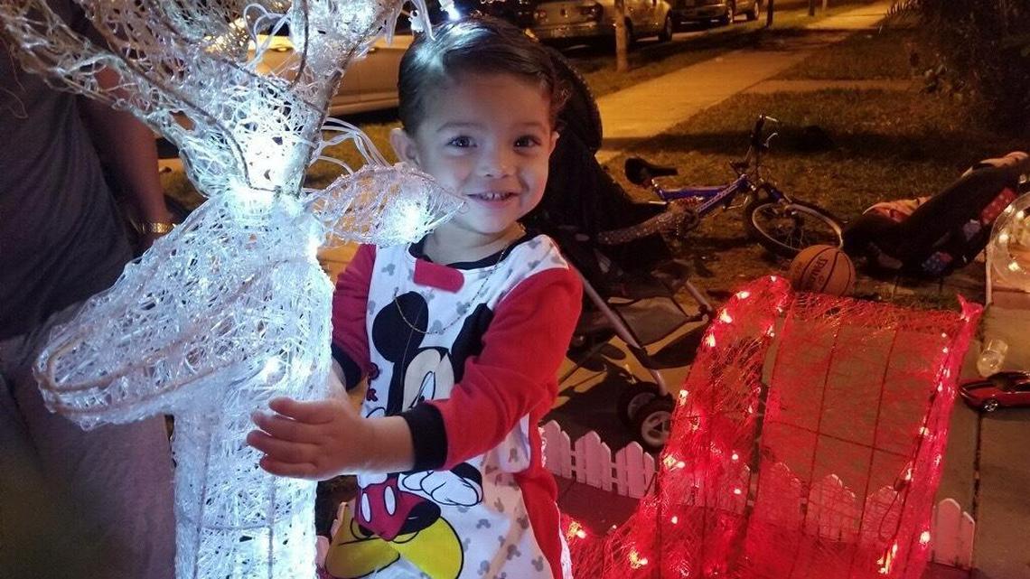 Two-year-old Alphonse Gonzalez poses outside his grandmother’s home around Christmastime.