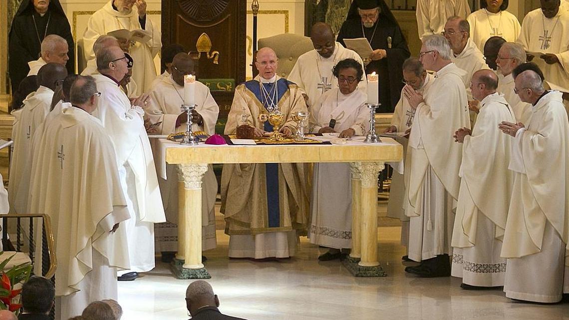 The Right Rev. Bishop Peter Eaton, center, leads the breaking of the bread after being installed as head of the Episcopal Diocese of Southeast Florida on Saturday, Jan. 30, 2016 at Trinity Cathedral in downtown Miami.