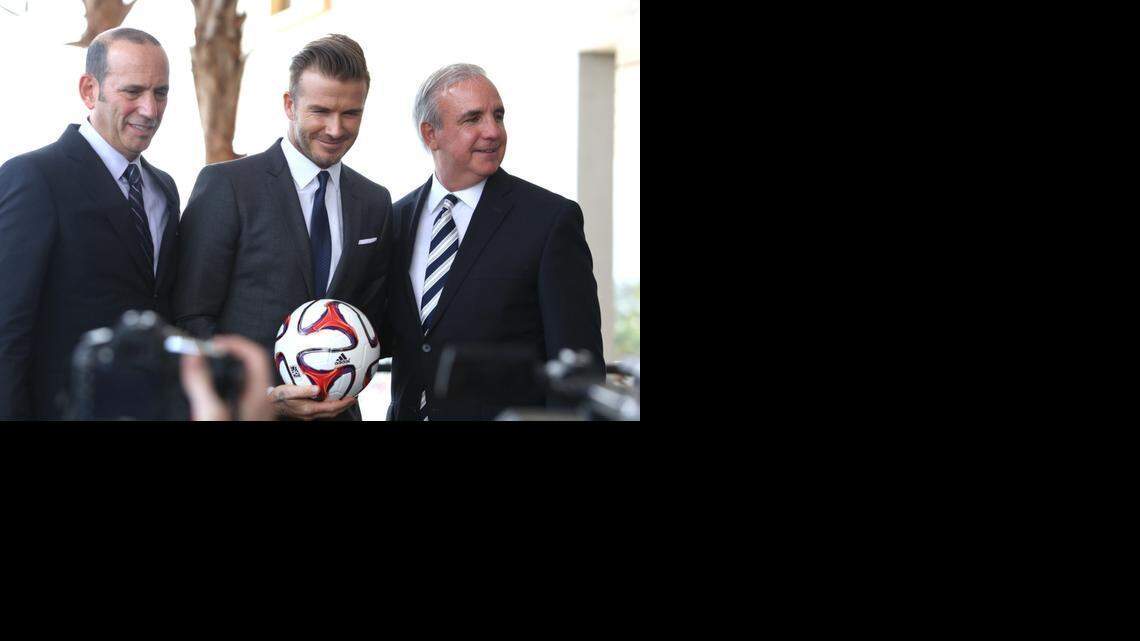 
David Beckham, center, announces his plans for a Miami MLS team at the Pérez Art Museum on Feb. 4, 2014. MLS Commissioner Don Garber stands to his left and Miami-Dade County Mayor Carlos Gimenez to his right.
