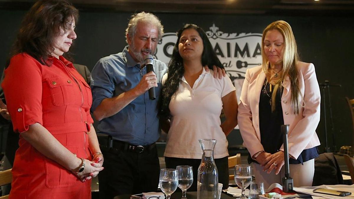 Pastor Ruben Jimenez (second from left) and other activists pray as they issue a public plea for President Donald Trump to issue Temporary Protected Status to Venezuelans living in the United States and extend TPS to other immigrants who already have it.