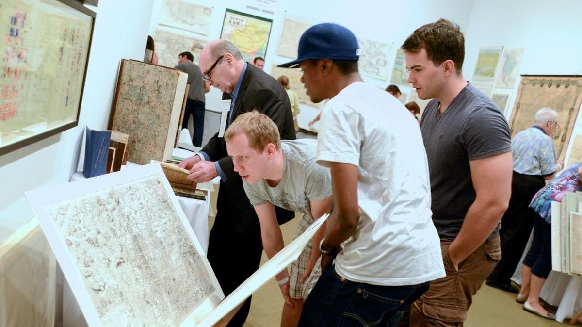 Visitors look at antique maps during HistoryMiami’s Annual International Map Fair.