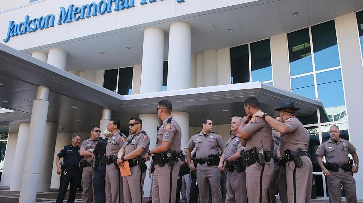 A group of Florida Highway Patrol officers gathered outside the Jackson Memorial Hospital Ryder Trauma Center as their colleague, Trooper Carlos Rosario, a 12-year veteran of the force, was been treated after he was nearly killed Friday when a car struck him around 9:30 a.m. Friday, March 17, 2017, on the Dolphin Expressway in Miami. FHP said Saturday that Rosario was ‘stable but still critical’ after emergency surgery for multiple injuries.