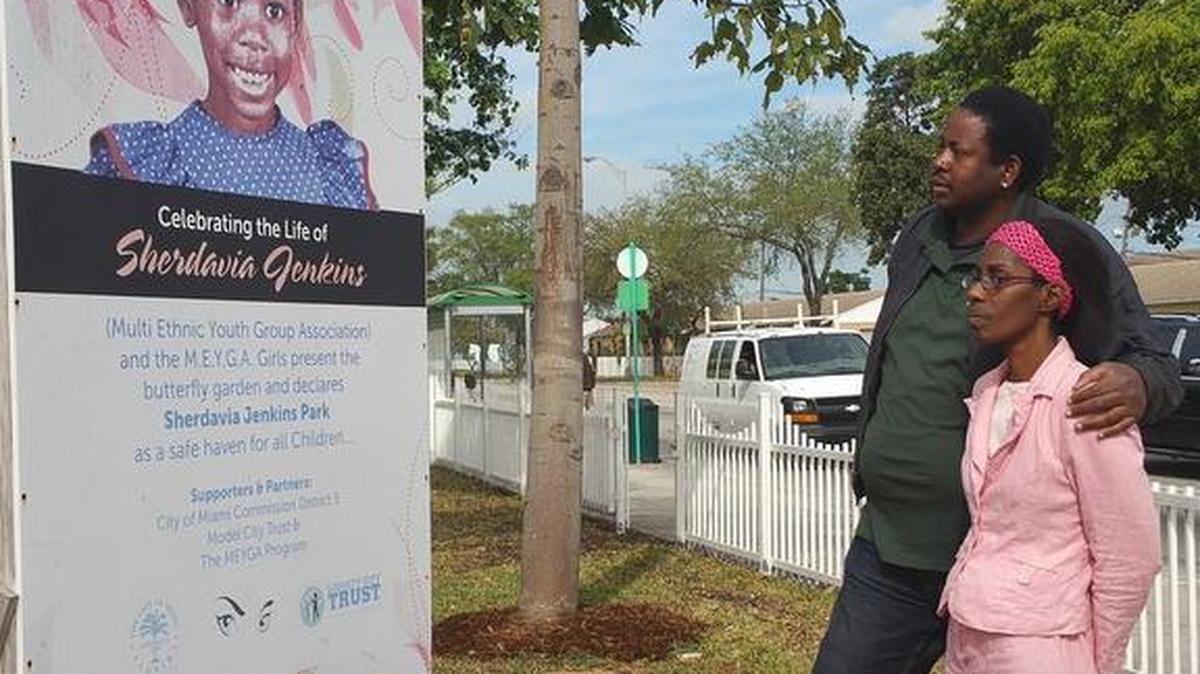 Sherdavia’s parents, David and Sherrone Jenkins, stand by a sign of their daughter Tuesday, March 22, 2016, at the Sherdavia Jenkins Peace Park. They were honoring her 19th birthday.