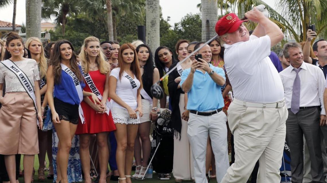 Donald Trump tees off at his Doral resort, with Miss Universe contestants as an audience, in 2015.