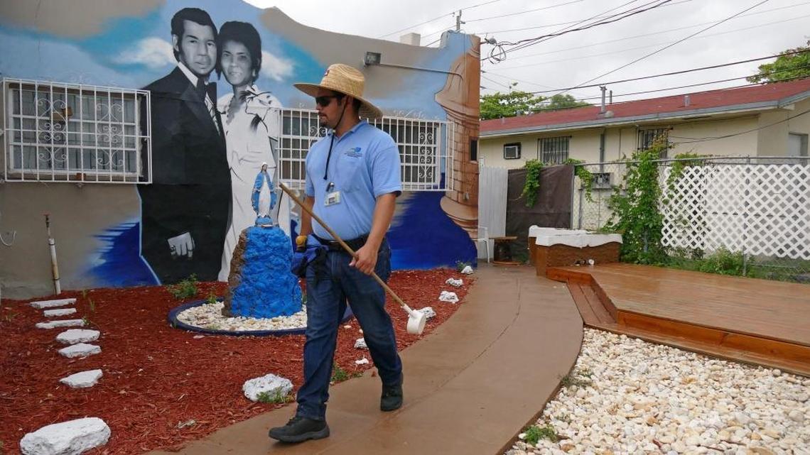 A Miami-Dade mosquito inspector looks for standing water and signs of live mosquitoes near Northwest 26th Street and Northwest First Avenue on Aug. 2, 2016.