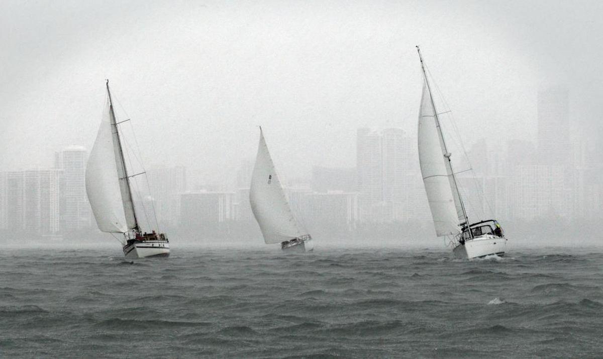 Three sailboats racing south on Biscayne Bay with the Miami skyline in the background at the start of the Bacardi Columbus Day Regatta LVII on Oct. 8, 2011.