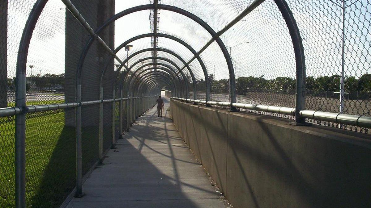 A man passes along the pedestrian walkway that connects to the Okeechobee Metrorail station in Hialeah.
