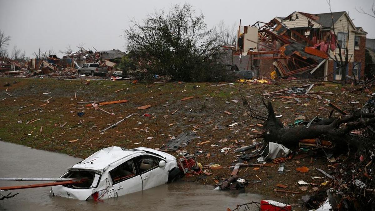 A car is flooded in a drainage ditch on Schrade Road in Rowlett, Texas, on Sunday, Dec. 27, 2015, a day after a tornado hit the area.