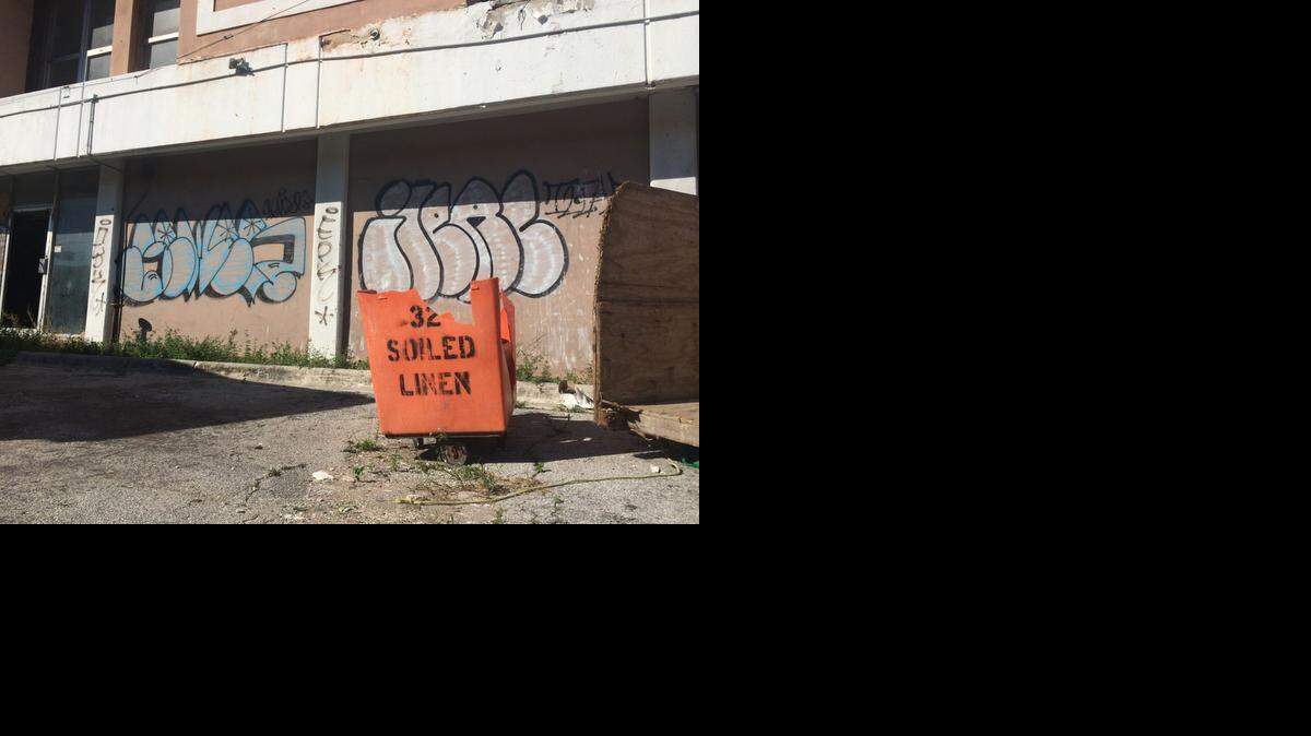 
A broken soiled linen bucket sits in front of the graffiti-covered hotel named The City Inn, 679 NW 79th St., just off Interstate 95. The hotel, which was once a Holiday Inn, has sat vacant for years.
