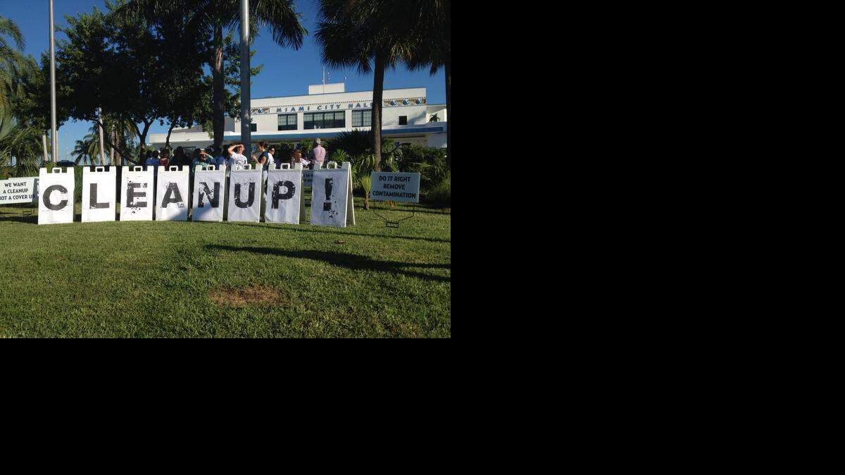 
Neighbors upset with Miami’s plan to remediate contaminated soil at Merrie Christmas Park gather outside City Hall before a public hearing on the city’s clean-up efforts.
