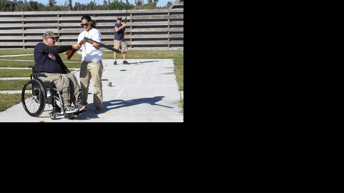 
From left, Francisco Abreu, who served in Korea for two years starting in 1974, used his Spanish Lanbur over-under (one barrel on top, one on bottom) shotgun for trap shooting in December. County recreation leader, Candice Croes, helps him reload while Army veteran Brian Bohne looks on.
