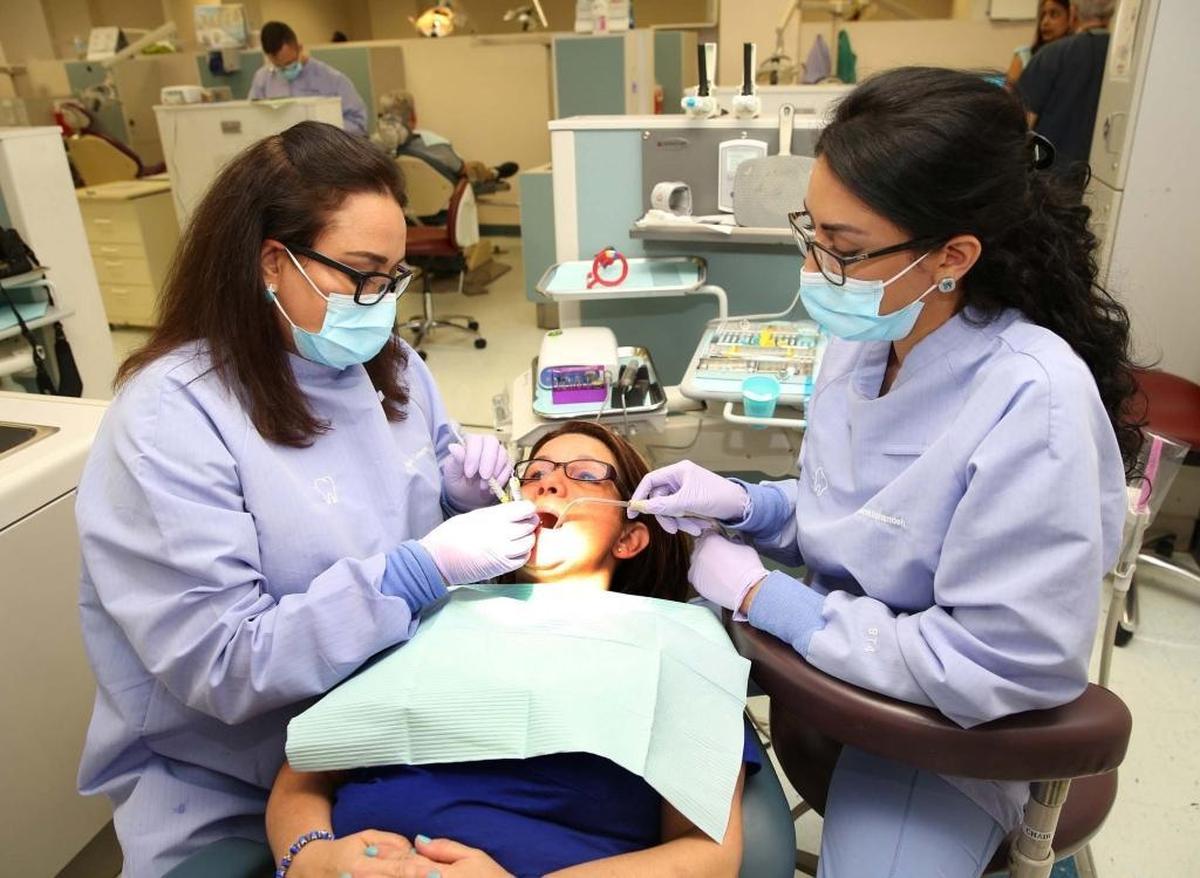 Naghmeh Taherian, left, works on a dental patient as her daughter Tara Derakhshandeh assists her at Nova Southeastern University-NSU Dental Program, where they both study dentistry together on Friday, April 28, 2017.