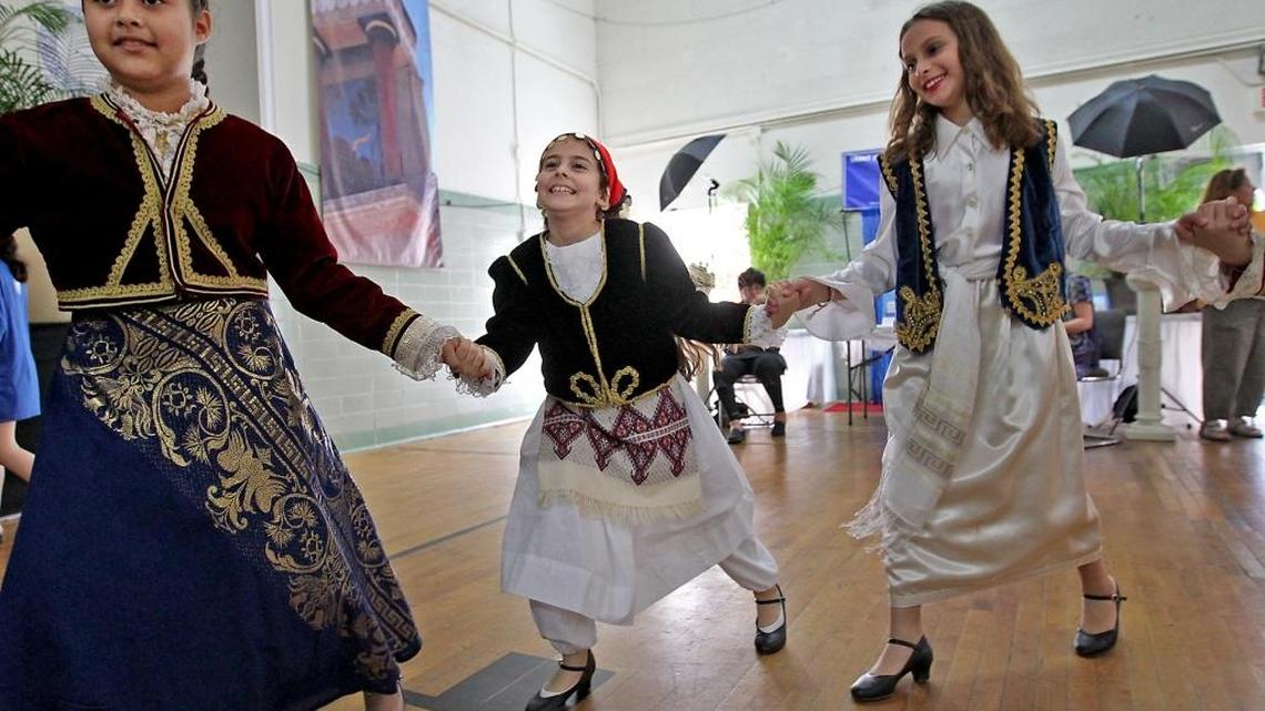 Tini Kasselakis, center, joins her junior dance group as they entertain the crowd at the annual Miami Greek Festival at St. Sophia Greek Orthodox Cathedral on Sunday, Feb. 26, 2017.