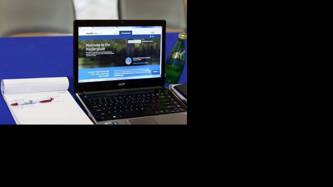 
A computer is ready to be used to help people at the Sunshine Life and Health Advisors purchase insurance under the Affordable Care Act at a kiosk setup at the Mall of Americas last year in Miami. More than 35,000 people in Florida lost ACA coverage this month after they missed a September deadline to prove they held citizenship or legal residency status in the U.S. 
