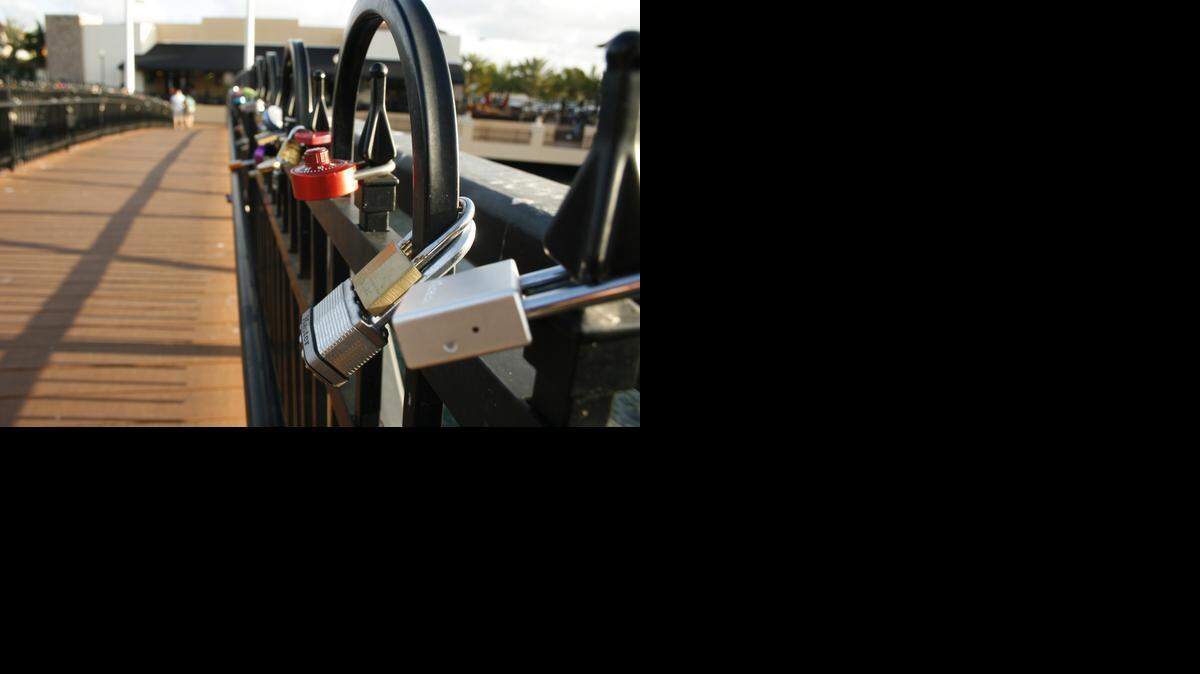 
Locks of Love are snapped onto Love Lock Bridge located at The Palms at Town & Country in Kendall. 
