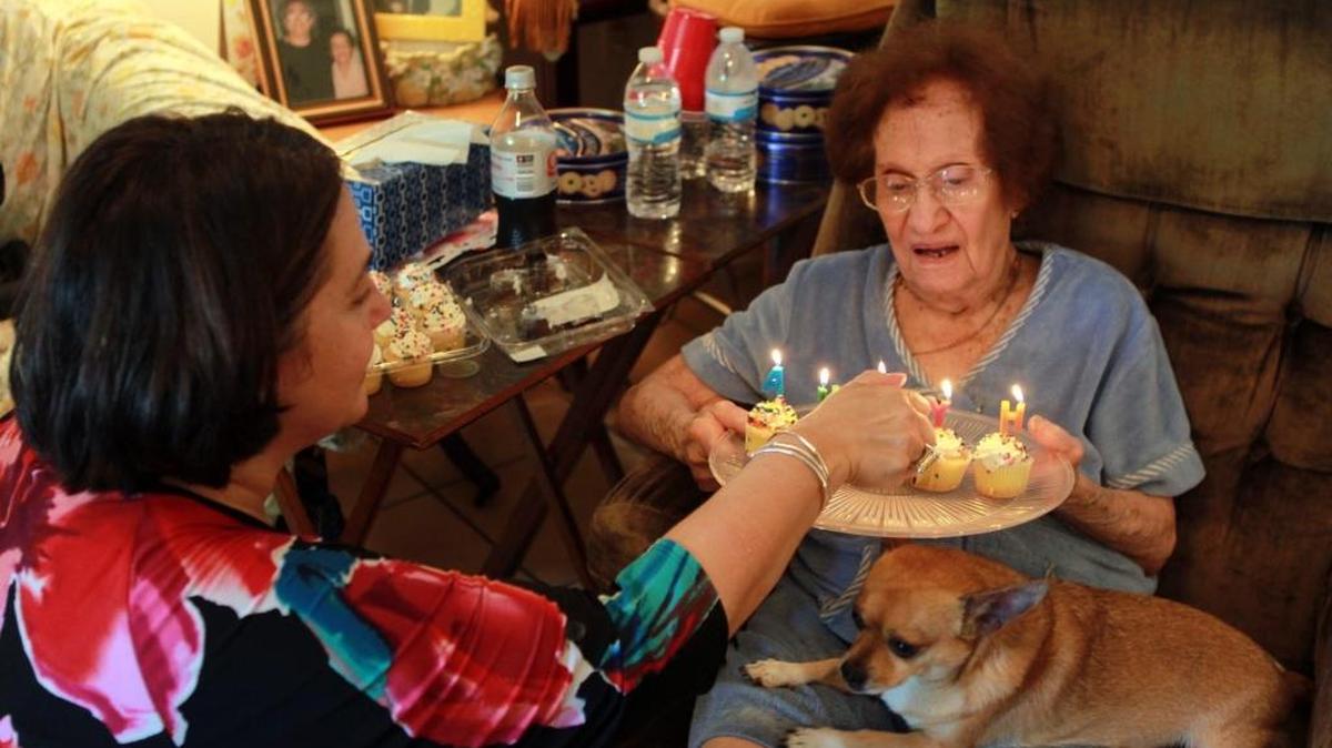 
Silvia Borges, left, lights candles for Hypha Bardowell Smatt, who is celebrating her 100th birthday on Sunday, Oct. 4. Here, she celebrates early on Thursday, Oct. 1, 2015.
