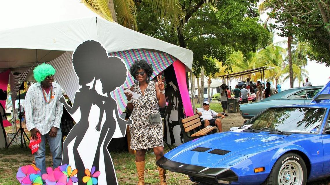 
In a green wig, Guy Forchion, director of Virginia Key Beach Park, stands outside a karaoke tent with a friend on Saturday, where a festival commemorating the 70th anniversary of the establishment of the park took place.

