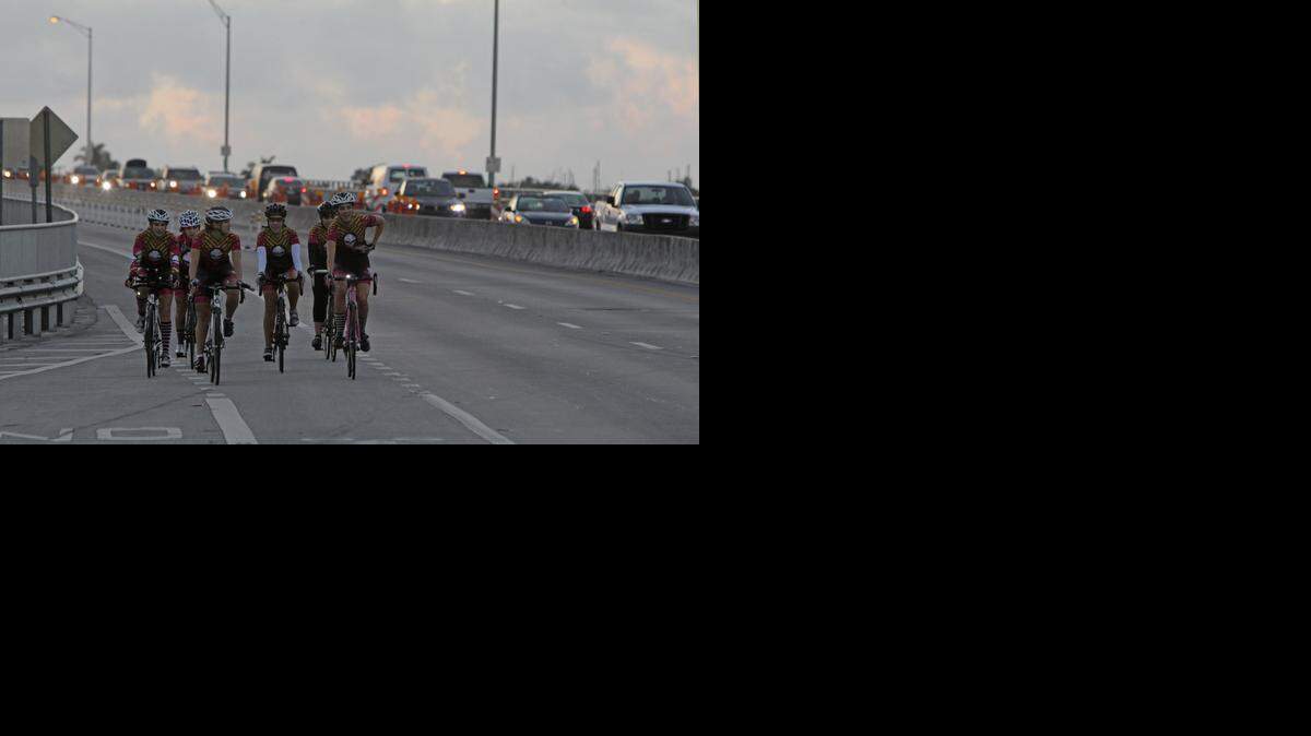 
Cyclists ride on the closed westbound side of the Bear Cut Bridge in January 2013.
