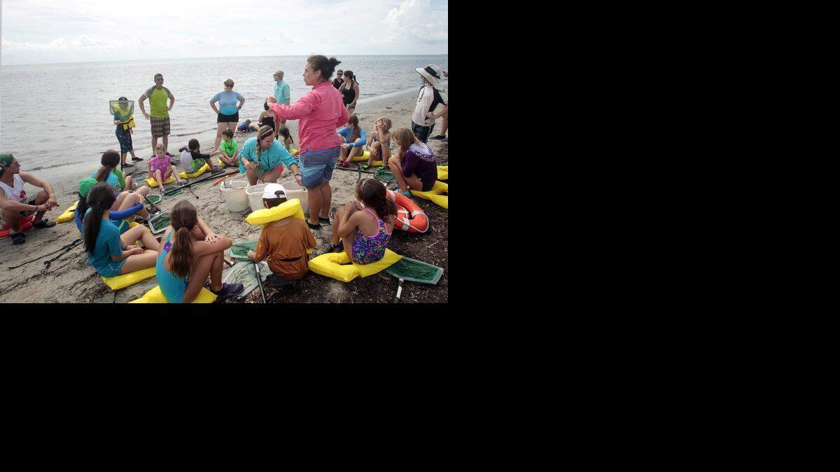 
Crandon Park Marjory Stoneman Douglas Biscayne Nature Center program coordinator and naturalist Sandra St. Hilaire, kneeling center, and naturalist Amel Saed, standing right center, display a variety of sea life obtained from dragging nets through the seagrass in Biscayne Bay.  Adults and children caught and learned about a variety of sea life and tested the quality of the water as part of World Water Monitoring Day. The nature center is at 6767 Crandon Blvd. on Key Biscayne.
