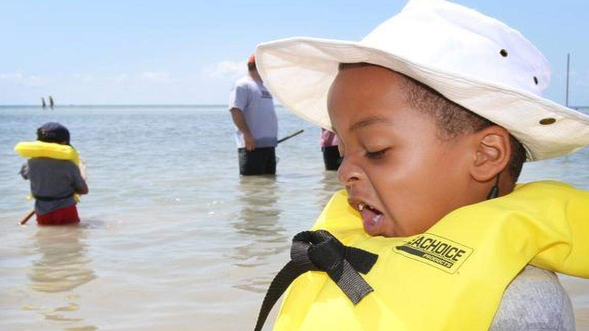 
Kindergartners from Saint Rose of Lima in Miami Shores went on a special field trip in 2010 to the Crandon Park Marjory Stoneman Douglas Biscayne Nature Center. The children, along with their teachers, parent chaperones and naturalists from the nature center, explored the seagrass beds using nets and found a variety of sea life. Sebastian Jenkins-St. Prix, 6, is slightly grossed-out by the slimy Sea Hare, (scientific name, Aplysia) he found in his net.

